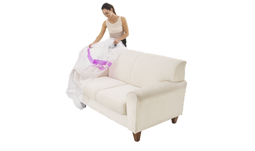 A woman in a white tank top and dark pants is covering a white fabric sofa with a plastic lounge cover with pink stripe, shown on a solid white background.