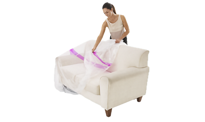 A woman is shown draping a clear plastic sofa cover with a pink stripe over a cream-colored armchair against a solid white background.
