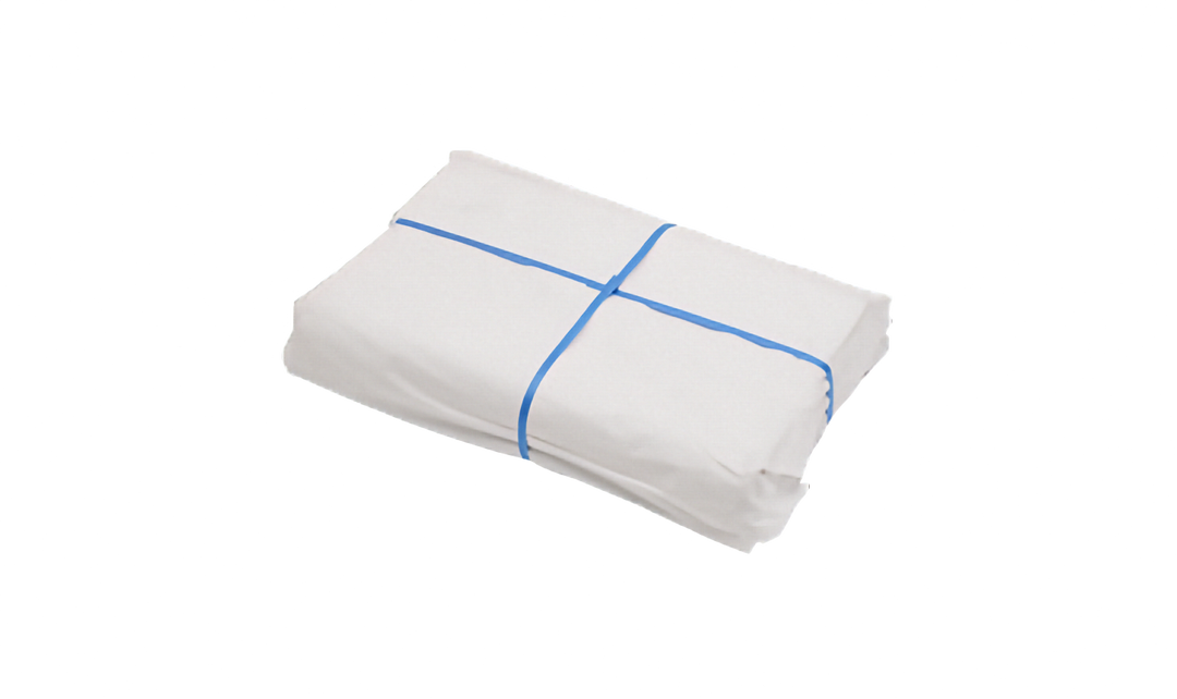 Bundled pack of white packing paper with blue strapping crossed around it. Pictured on a plain white background.