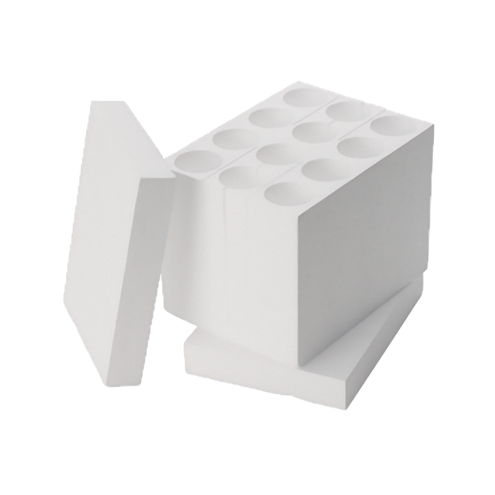 A white rectangular polystyrene wine bottle insert with multiple circular wells to fit inside a book and wine box. Shown with a separate matching lid leaning against it and base on a plain white background.